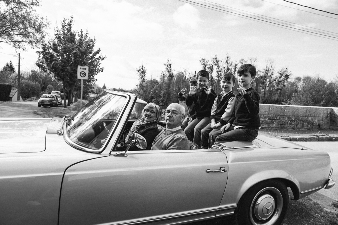 séance photo famille intergénérationnelle avec grands-parents et petits-enfants dans une voiture ancienne à Auxerre